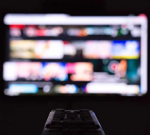 a remote control pointing at lots of screens showing the diverse range of options when recording voice overs for commercials with Neil Williams English male voice over artist